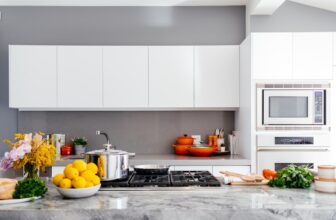 A person using ergonomic kitchen tools while cooking, demonstrating proper hand and wrist positioning.