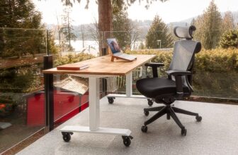 A well-organized ergonomic workspace with a computer setup, highlighting monitor height, chair support, and keyboard placement.