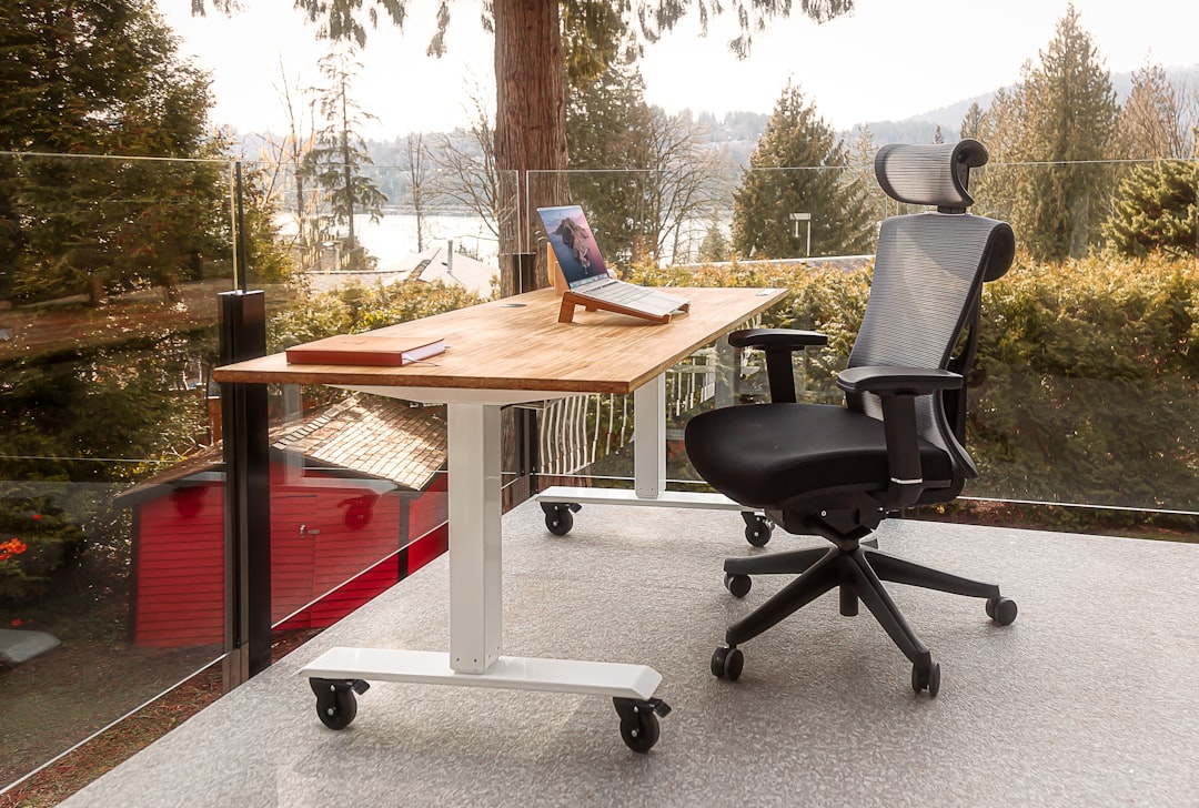 A well-organized ergonomic workspace with a computer setup, highlighting monitor height, chair support, and keyboard placement.