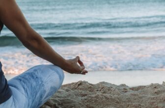 A serene scene of a person practicing deep breathing in a peaceful outdoor setting, surrounded by nature.
