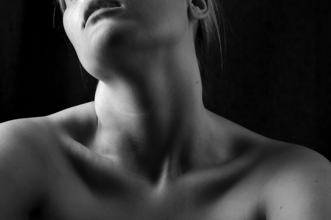 A person practicing gentle neck stretches in a serene environment, showcasing relaxation and relief from tension.